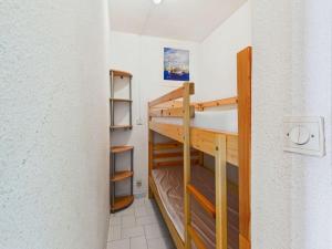 a small room with a bunk bed and shelves at Studio cabine RDC, terrasse, 4 pers, parking - FR-1-423-26 in Le Grau-dʼAgde