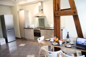 a kitchen with a table with a laptop on it at City Inn Riga Apartment, Old Town Panorama view with parking in Riga