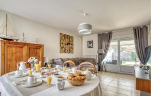 a dining room with a table with food on it at 3 Bedroom Gorgeous Home In Rochefort in Rochefort