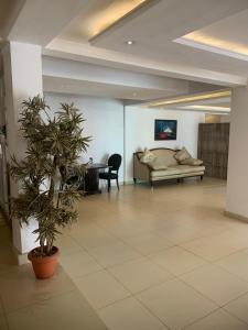 a living room with a couch and a table at Swiss pearl continental hotels and apartments in Abuja