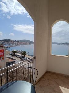 a balcony with a view of a body of water at Sun-up in Rogoznica +2 photos