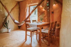 a dining room with a table and chairs and a window at Private Eco Cottage in Nature in Šulinci +36 photos