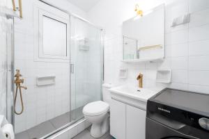a white bathroom with a toilet and a glass shower at The Greek Getaway in Lóngos +21 photos