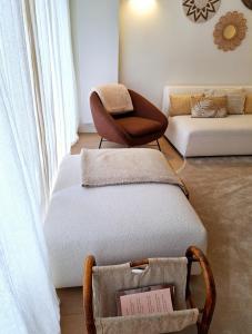 a living room with a couch and a chair at Appartement Wellington D3 Knokke full service et parking in Knokke-Heist +21 photos