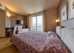 Ένα ή περισσότερα κρεβάτια σε δωμάτιο στο Hotel Belvedere Ranco