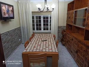 a dining room with a table with a checkerboardkered tableablish at Casa de Ferreñas-5 dormitorios in Esteiro