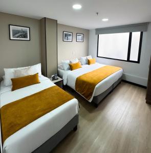 Postel nebo postele na pokoji v ubytování Hotel WLH Gold Bogota