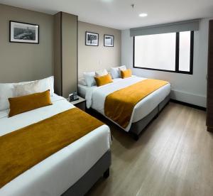 Postel nebo postele na pokoji v ubytování Hotel WLH Gold Bogota