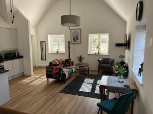 a living room with a couch and a table at Blundens Holiday Lets - Hatfield in Chichester