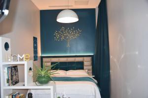 a bedroom with a bed with a tree on the wall at Home in Paris Eiffel Tower & Champs Elysees in Paris