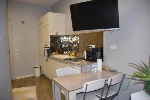 a kitchen with a table with chairs and a counter top at Home in Paris Eiffel Tower & Champs Elysees in Paris