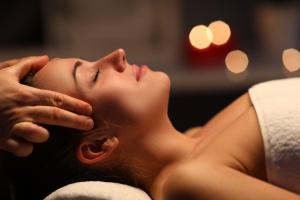 a woman laying on a towel with her hand on her face at Domaine de la Blonnerie in Feings