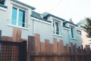 a wooden fence in front of a house at L'Unique- Maison de famille en Plein Centre-Ville in Tours +69 photos