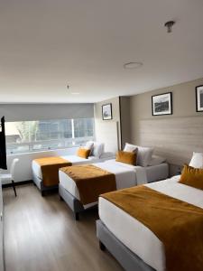 Postel nebo postele na pokoji v ubytování Hotel WLH Gold Bogota