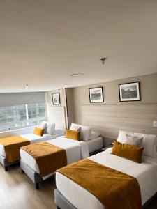 Postel nebo postele na pokoji v ubytování Hotel WLH Gold Bogota