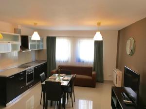 a kitchen and living room with a table and chairs at Elysium in Bucharest