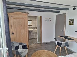 a room with a door and two chairs and a table at Studio charmant à Valff avec jardin privé - 20 m² in Valff
