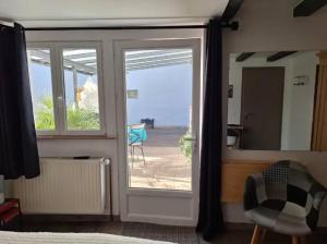 a bedroom with a sliding glass door with a view of the beach at Studio charmant à Valff avec jardin privé - 20 m² in Valff