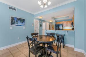 a kitchen and dining room with a table and chairs at Crystal Tower 1906 by Vacation Homes Collection in Gulf Shores
