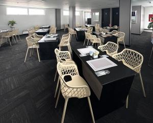 a dining room with tables and chairs and tablesktop at Hotel WLH Silver Corferias in Bogotá