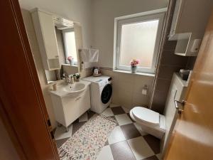 a bathroom with a sink and a toilet and a window at De lux Do in Zagreb +47 photos
