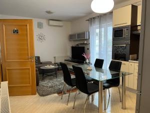 a kitchen and dining room with a table and chairs at De lux Do in Zagreb