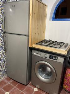 a kitchen with a stove and a washing machine at Ba Ali in Rabat +10 photos