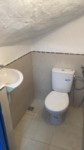 a bathroom with a toilet and a sink at Ba Ali in Rabat