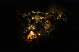 an overhead view of a lit up tent at night at Lumbre Forest Lodge in Salento