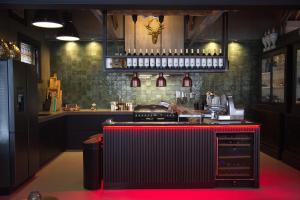 a bar with a red counter in a room at Roomz B&B in Kloosterzande