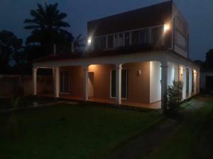 a house lit up at night with lights at Stay Hostel in Canavial
