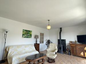 a living room with a couch and a tv at Maison charmante près du lac d'Esparron, 2 chambres, parking - FR-1-822-10 in Esparron-de-Verdon