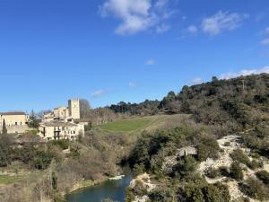 a castle on top of a hill next to a river at Maison charmante près du lac d'Esparron, 2 chambres, parking - FR-1-822-10 in Esparron-de-Verdon