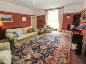 a living room with a couch and a rug at Westward Park in Wigton
