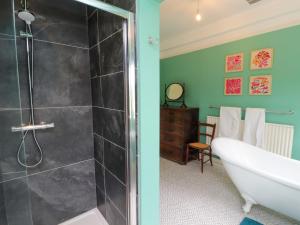 a bathroom with a bath tub and a shower at Westward Park in Wigton +48 photos