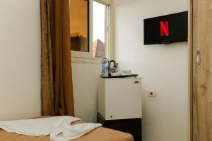 a room with a small refrigerator and a window at Giza Pyramids view hotel in Giza