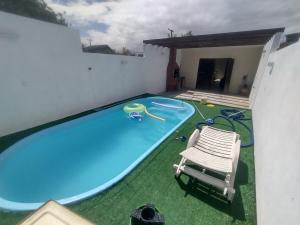 an image of a swimming pool with a chair and a chair at Casa praia in Pelotas