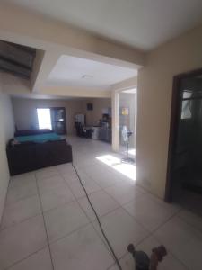 a living room with a bed and a dog in it at Casa praia in Pelotas
