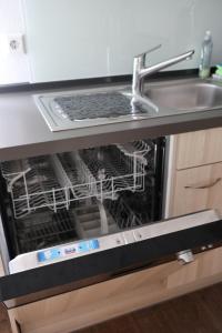 a dishwasher with a laptop sitting inside of it at Ferienwohnung am Brunnen in Titisee-Neustadt