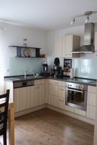 a kitchen with a sink and a stove top oven at Ferienwohnung am Brunnen in Titisee-Neustadt