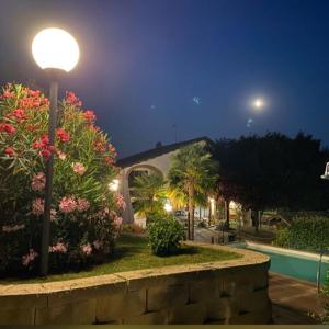 a street light in front of a house with flowers at Bed And Breakfast Olimpia in San Salvatore Monferrato