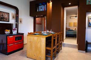 a kitchen with a island with a red cabinet at Countryhouse Villa with pool & private parking in Heraklio Town