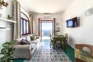 a living room with a couch and a table at Villa Panorama in Positano