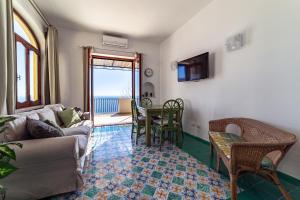 a living room with a couch and a table at Villa Panorama in Positano