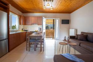a kitchen and living room with a couch and a table at Lemon House Lefkada in Lefkada