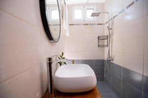 a white toilet in a bathroom with a shower at Lemon House Lefkada in Lefkada +7 photos