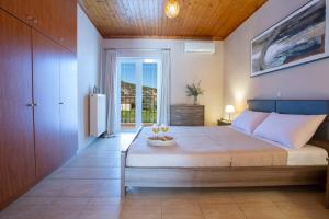 a bedroom with a large bed with a table on it at Lemon House Lefkada in Lefkada