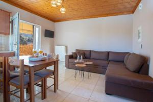 a living room with a couch and a table at Lemon House Lefkada in Lefkada