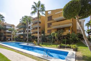 an apartment with a swimming pool in front of a building at La Recoleta ID198 in Cabo Roig