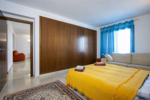 a bedroom with a yellow blanket on a bed at La Recoleta ID198 in Cabo Roig +27 photos